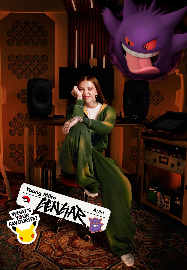 Artist Young Miko sits in a studio. Overhead, Gengar sticks its tongue out.